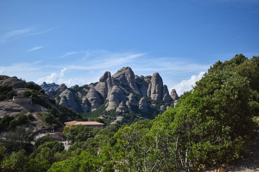 Wide view of Montserrat mountains with greenery and rocky peaks