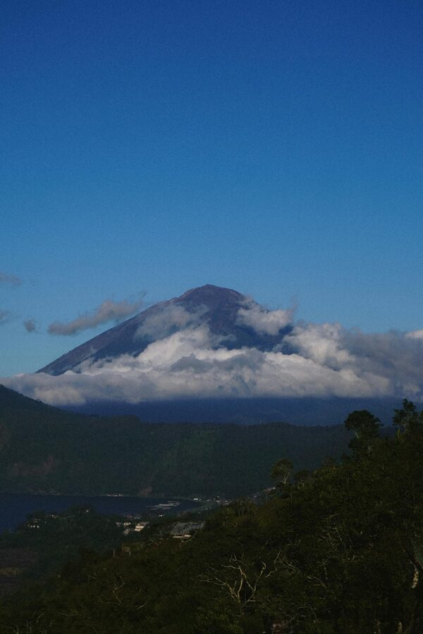 View of Mount Agung enveloped in clouds from the Mount Batur viewpoint at sunrise