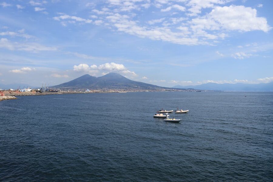 Aerial view of Mount Vesuvius rising over the Bay of Naples with sailing boats below