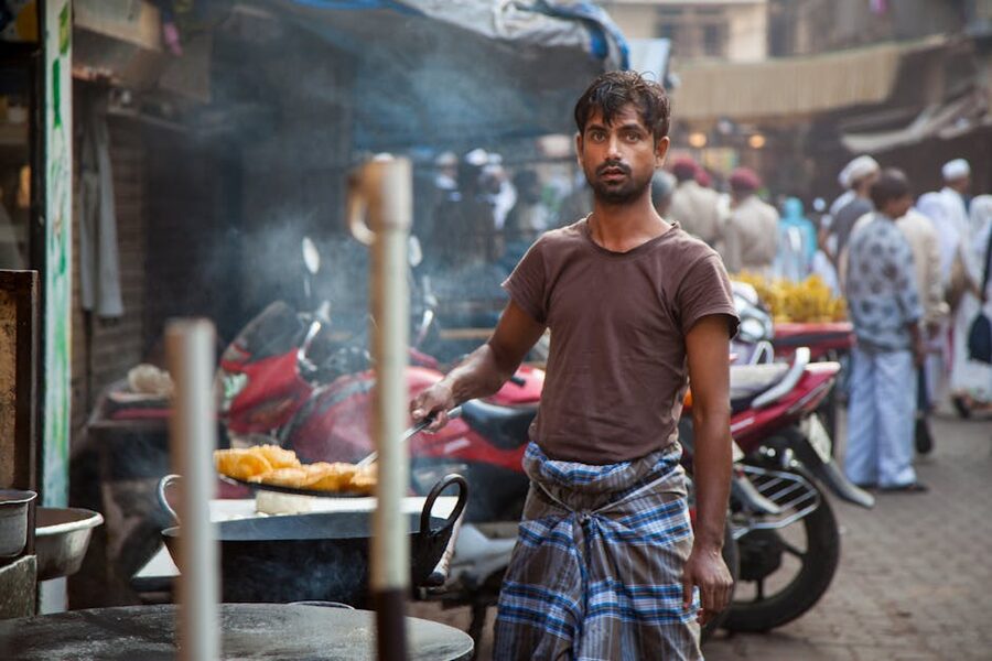 Street food vendor frying snacks in Mumbai market