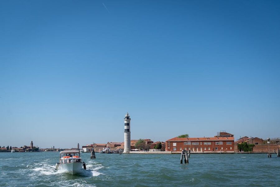 Speedboat passing the Murano lighthouse on the lagoon