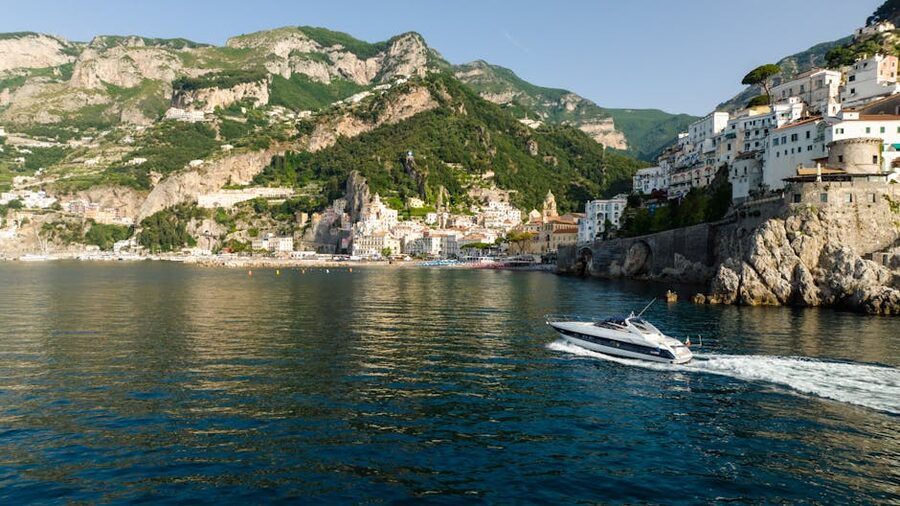 A boat cruising along the Amalfi coastline