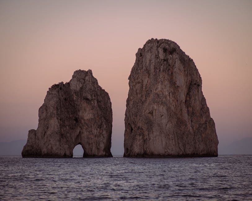 Faraglioni rocks at sunset with golden Mediterranean light