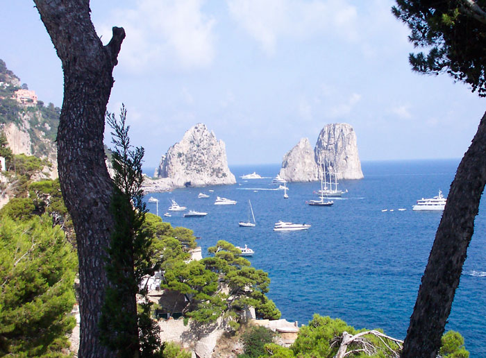 The three Faraglioni rock stacks of Capri rising from the Mediterranean Sea