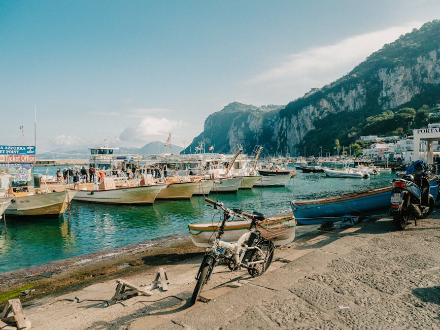 Capri marina with boats moored along the shore in summer light