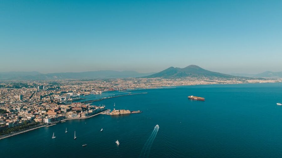 Aerial view of Naples coastline with Mount Vesuvius rising in the distance