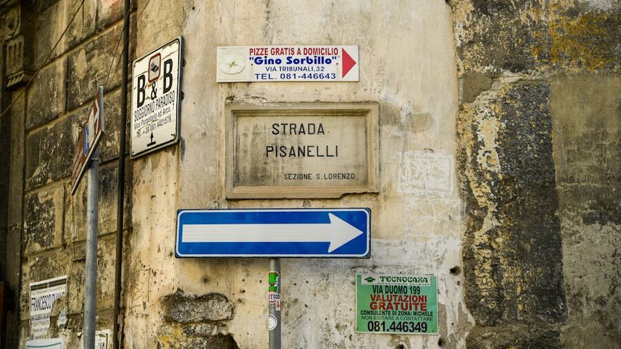 Naples historic street signs on a stone wall