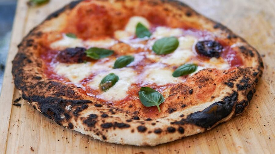 Wood-fired Margherita pizza fresh from oven
