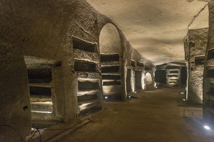 Wide stone arch carved into the tuff inside the Catacombs of San Gennaro