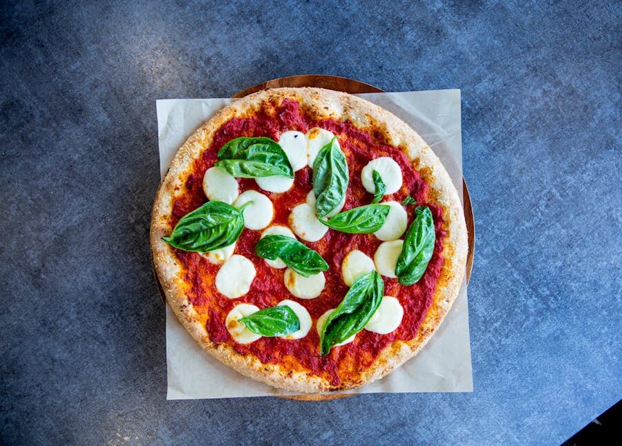 Margherita pizza top view with basil leaves