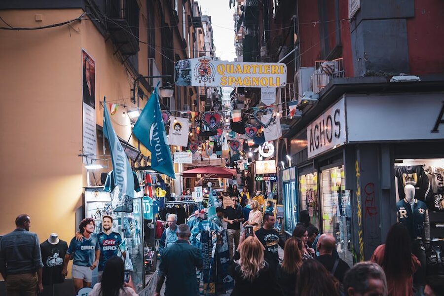 Crowded Quartieri Spagnoli market alley with shoppers in Naples
