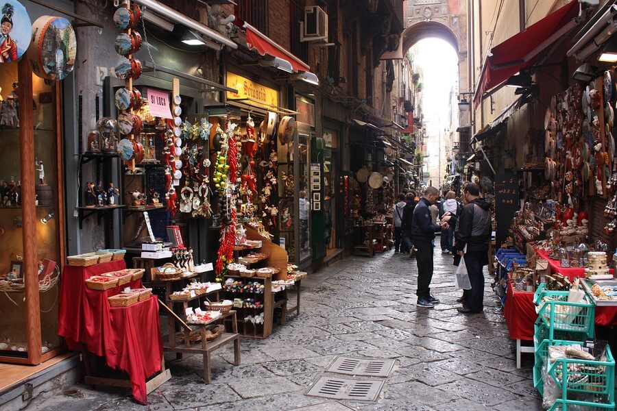 Spaccanapoli alley with shops and tourists in Naples