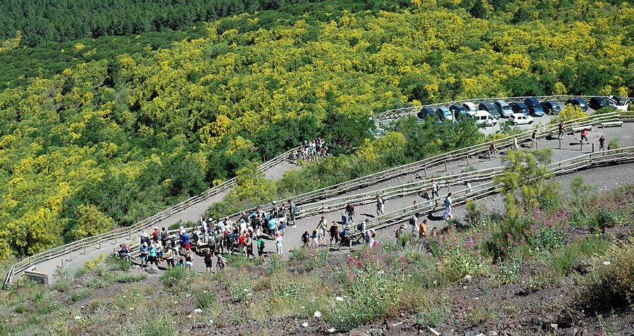 Winding path up Mount Vesuvius volcano with hikers