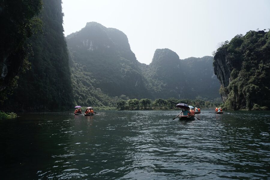 Tourists paddle through stunning limestone cliffs in Ninh Binh Vietnam