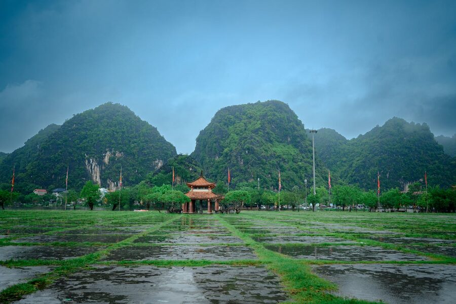 Serene beauty of Hoa Lu Temple surrounded by lush green hills in Ninh Binh Vietnam