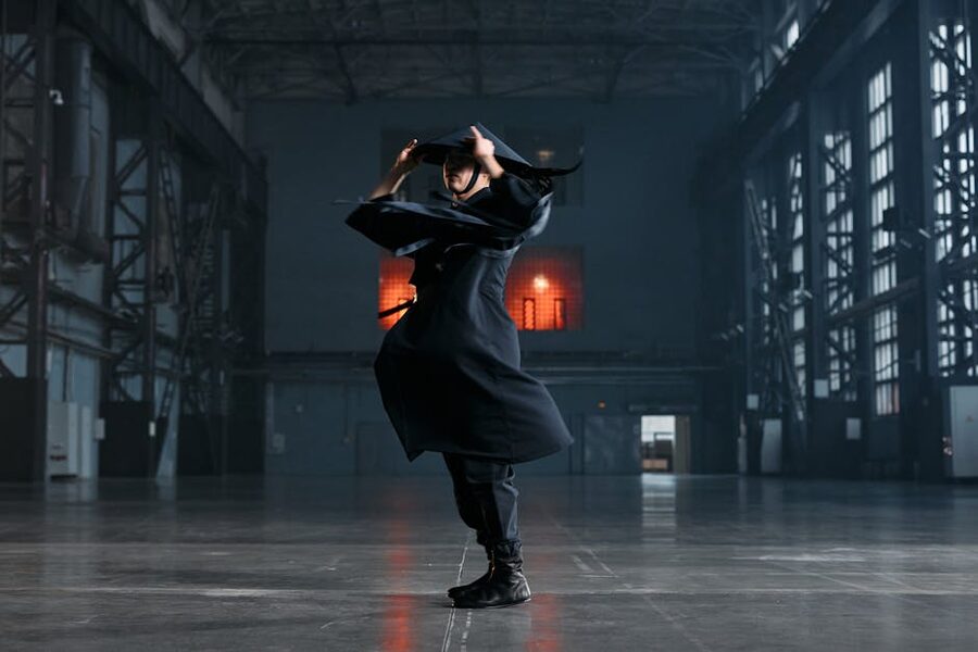 Ninja in black costume performing martial arts