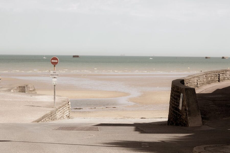 Beach view at Arromanches-les-Bains showing harbour remnants in the sea