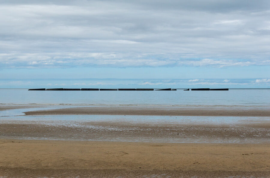 Mulberry harbour caissons on Arromanches beach at low tide