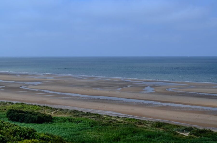 Omaha Beach in Normandy with calm sea and wide sand at low tide