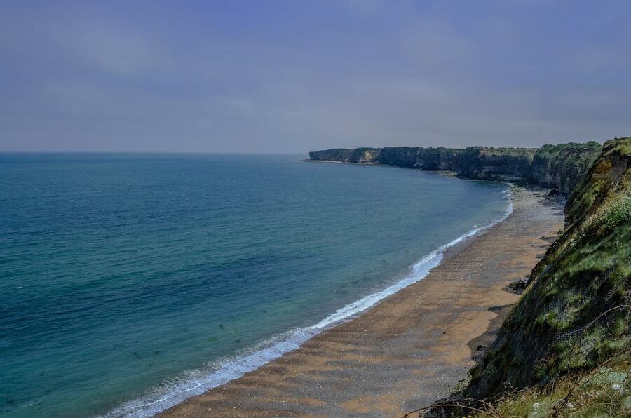 Cliffs at Pointe du Hoc Normandy with serene beach below