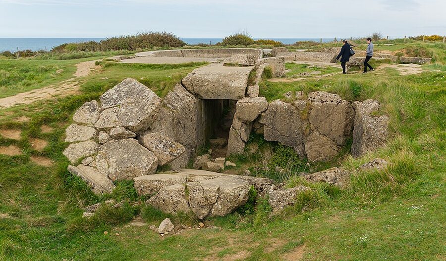 Visitors exploring a German bunker at Pointe du Hoc