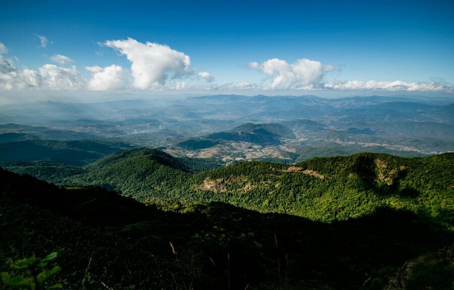 Expansive view of lush green mountains and clouds near Chiang Mai Thailand