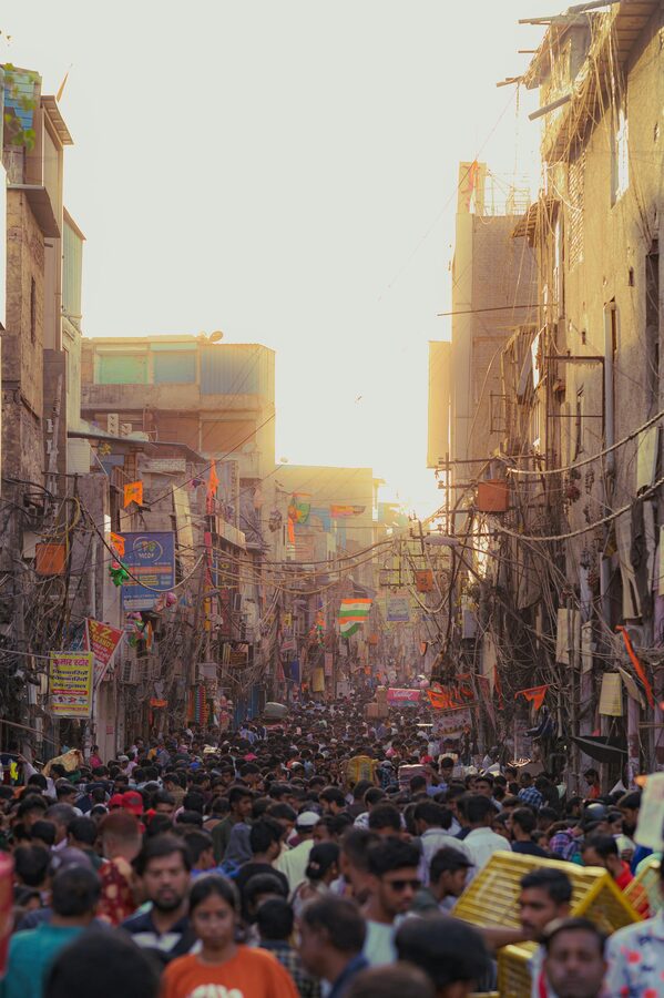 Dense street scene in Old Delhi showing shops, signs, and crowds