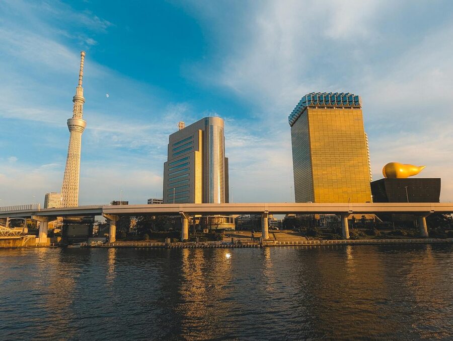 Tokyo Skytree tower seen from across the Sumida River with surrounding buildings