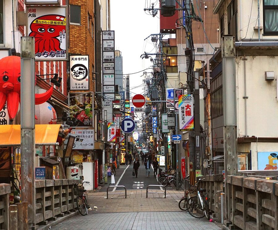 Osaka Dotonbori at night with neon glow and pedestrians