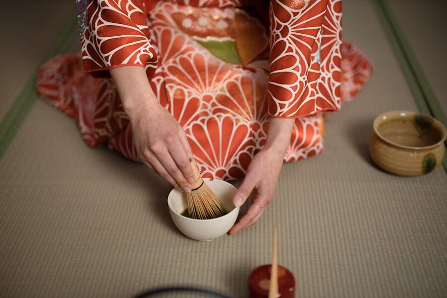 Kimono-clad instructor preparing matcha in Osaka class