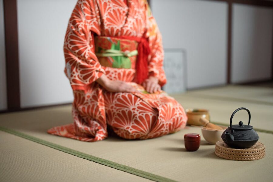 Woman in kimono performing Osaka matcha tea ceremony with bowl