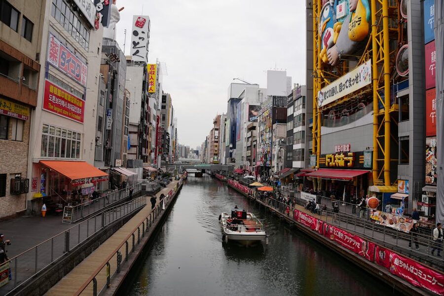 Dotonbori canal in Osaka at dusk with neon signs