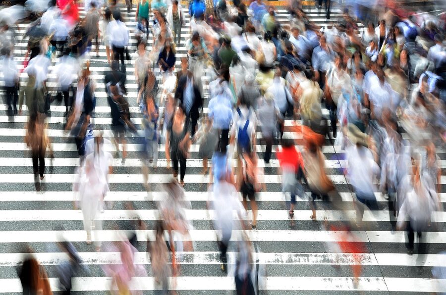 Pedestrians crossing a busy Osaka street