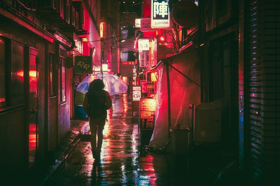 Osaka night alley with umbrella figure and neon lights