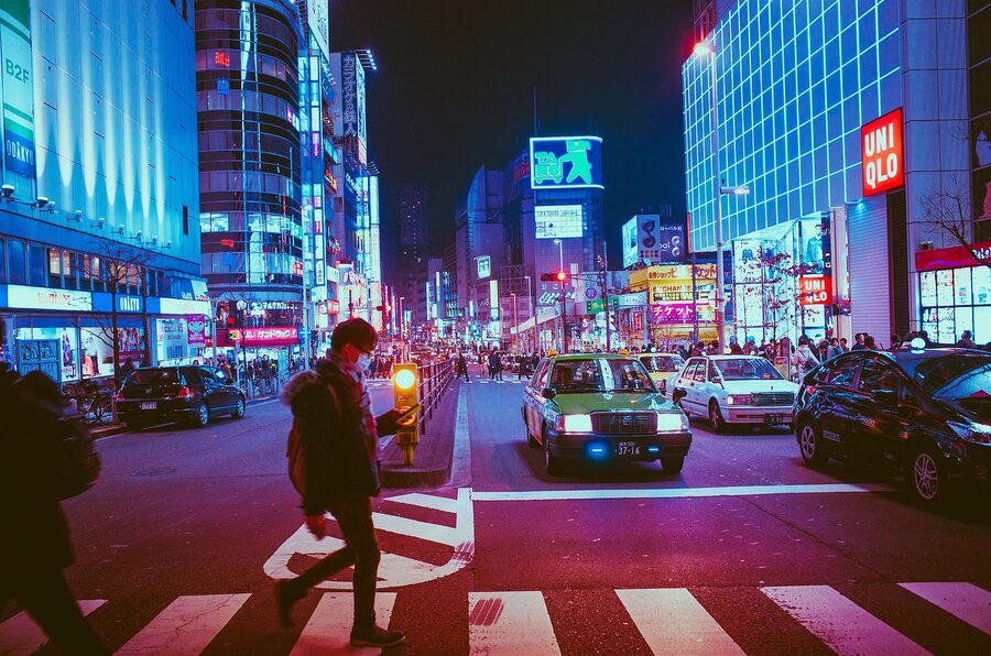 Osaka pedestrian crossing at night with illuminated shops