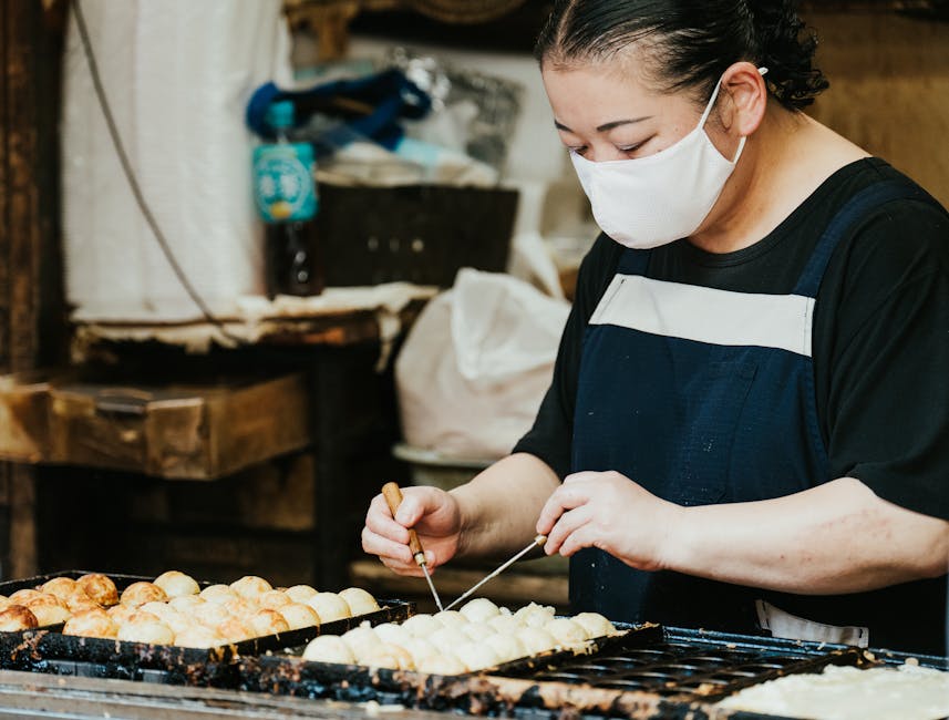 Takoyaki street vendor cooking on a grill Osaka
