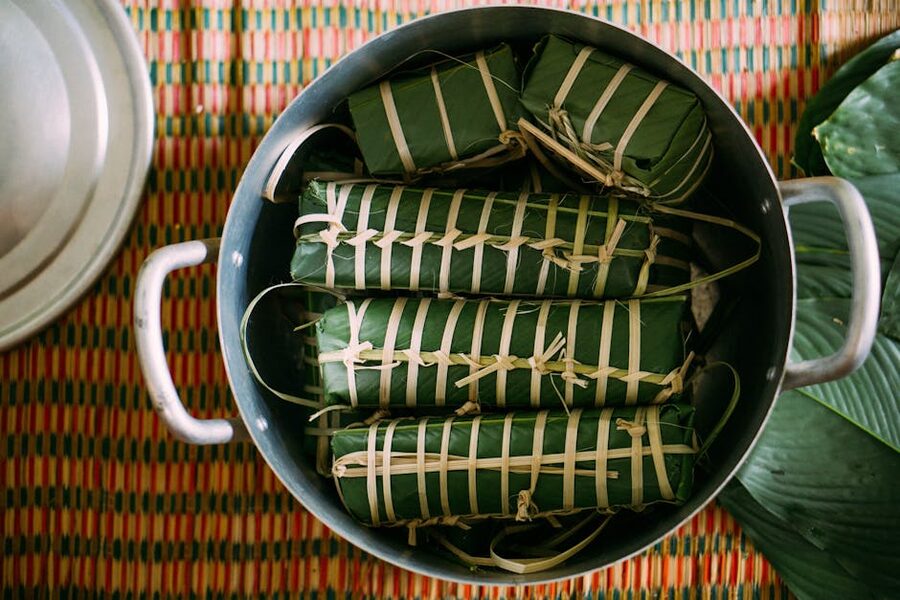 Traditional Khmer cakes wrapped in banana leaves at a Cambodian market