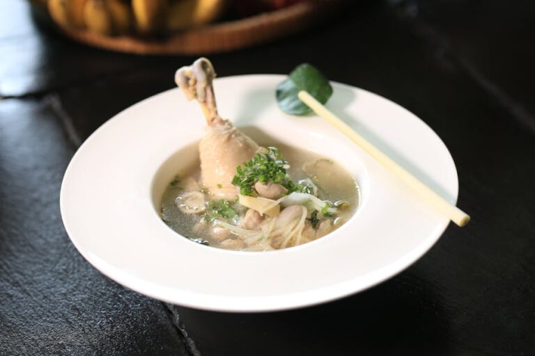 Bowl of Cambodian chicken soup with lemongrass and herbs