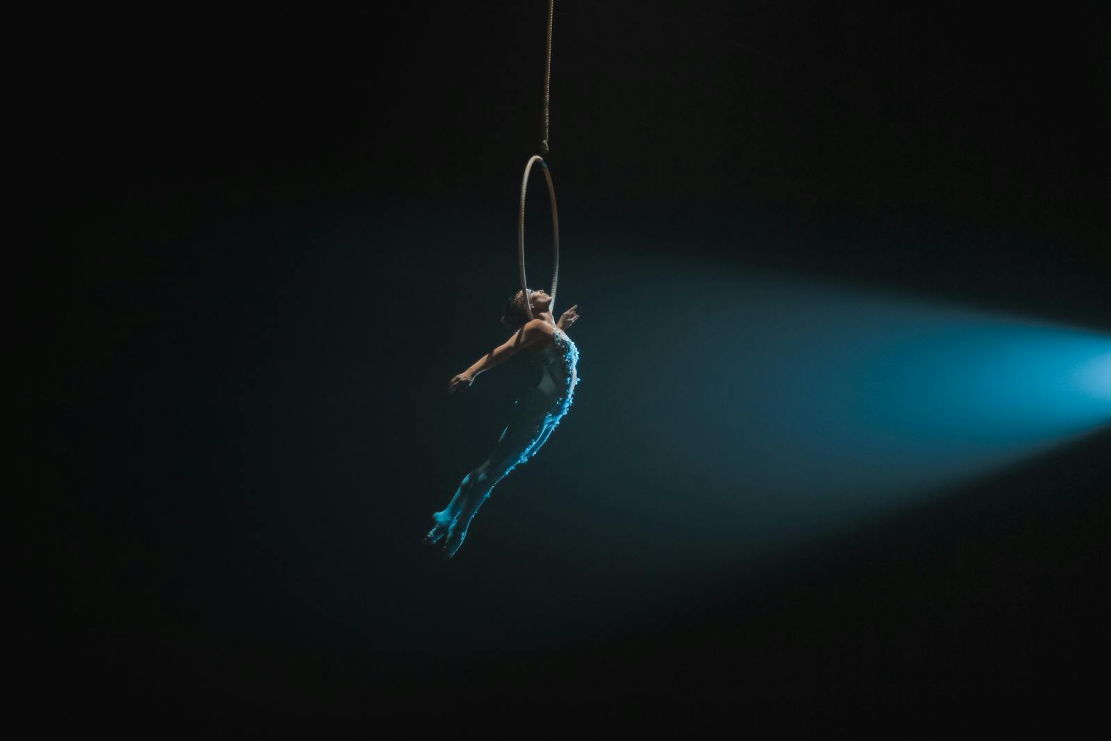 Aerial hoop acrobat performing in a circus tent