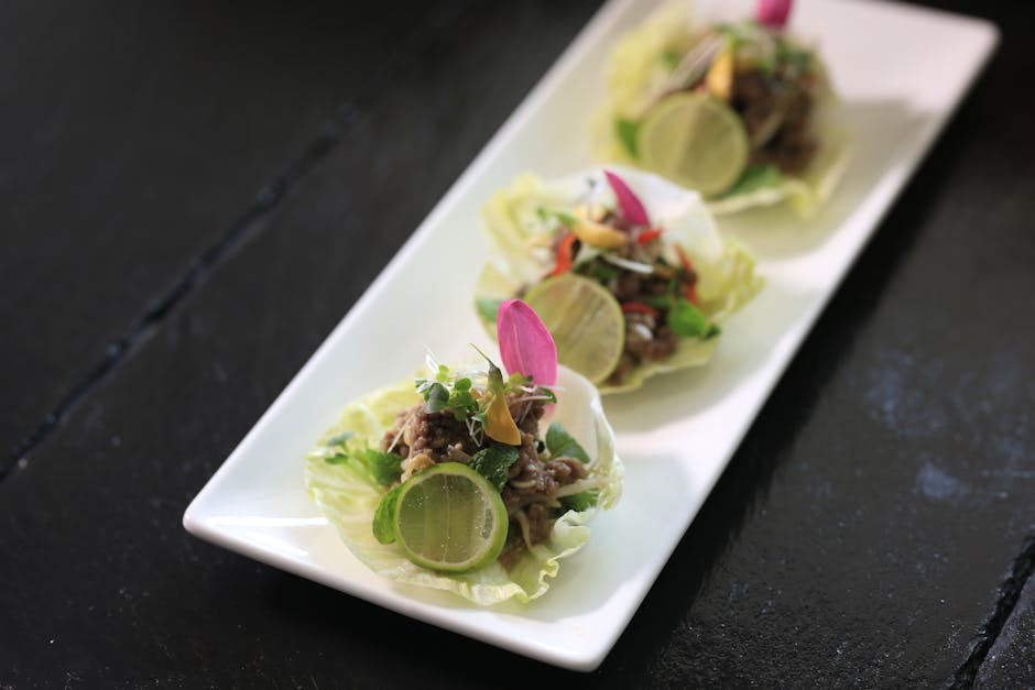 Fresh Cambodian lettuce wraps served with lime wedges on a plate