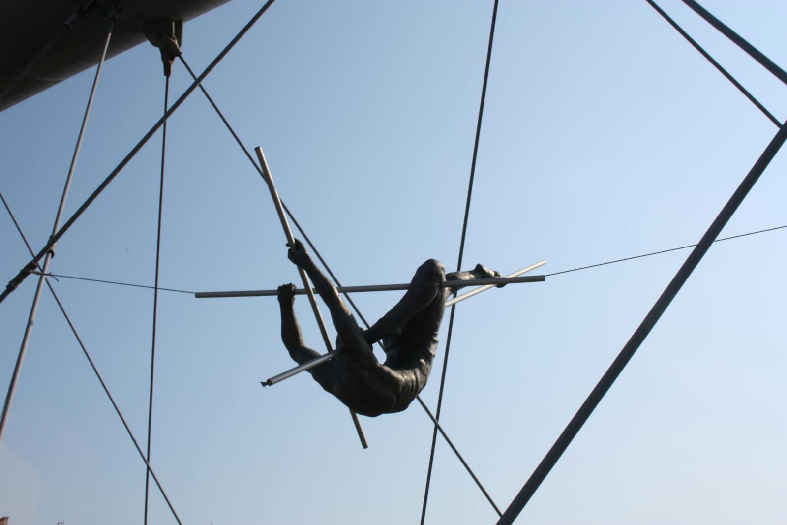 Silhouette of a circus acrobat performing on a trapeze