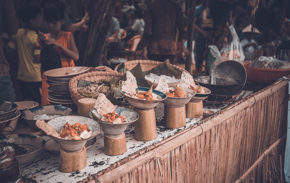 Bowls of Cambodian street food displayed at a lively market
