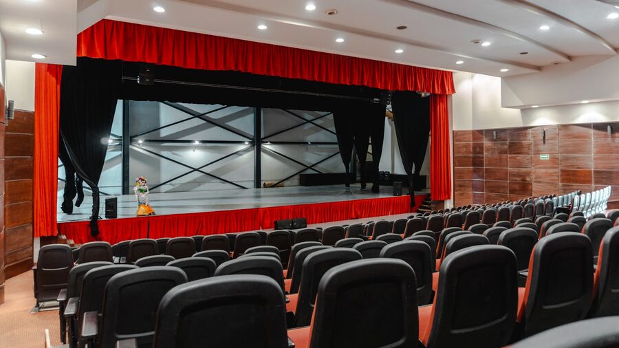 Theater seating with red curtains ready for a performance