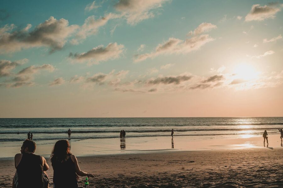 People on Bali beach at sunset