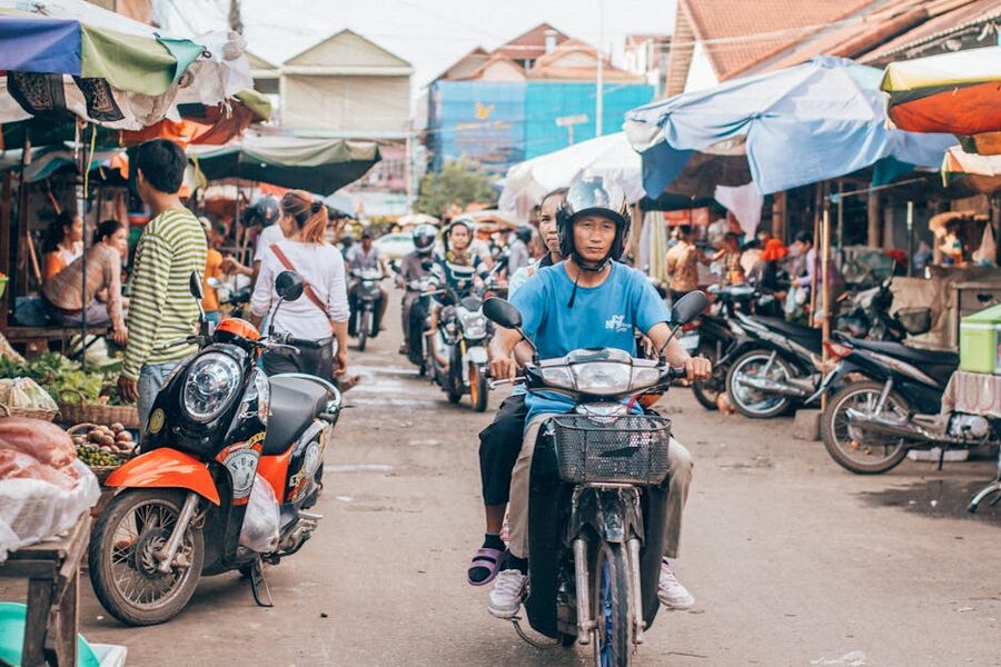 Motorcyclists on a busy Siem Reap street