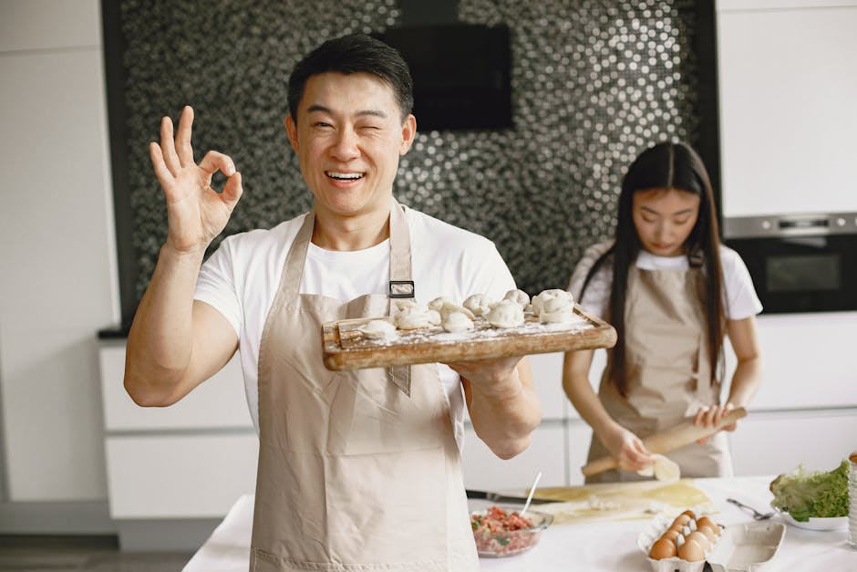 Asian chef preparing food at a modern kitchen counter