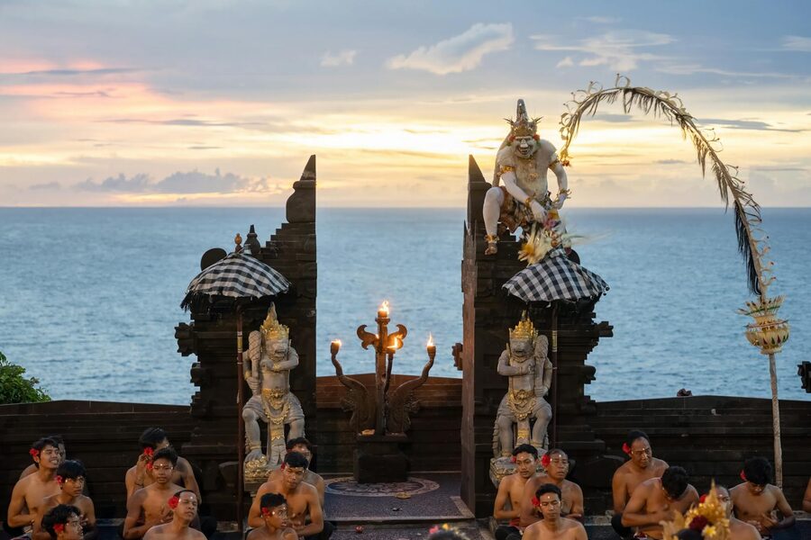 Kecak dancers performing at Uluwatu Temple at sunset