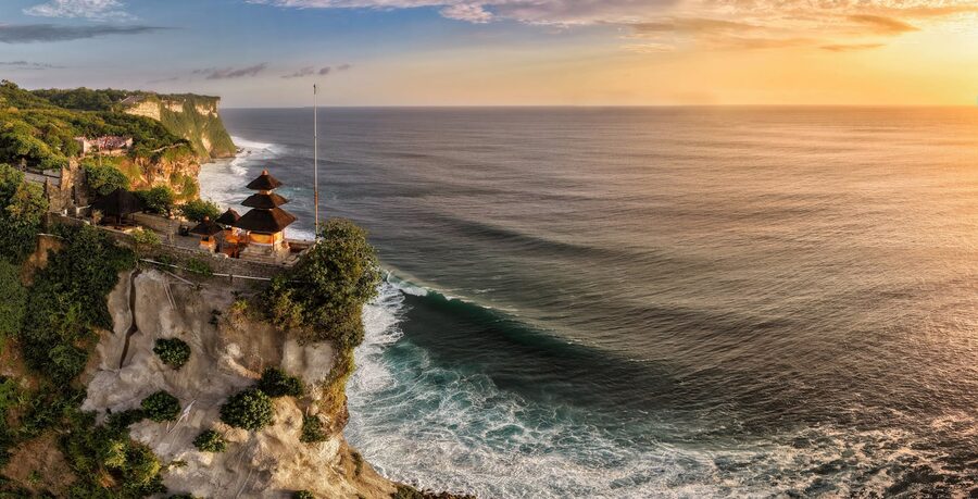 Aerial view of Uluwatu Temple on cliffs overlooking the ocean