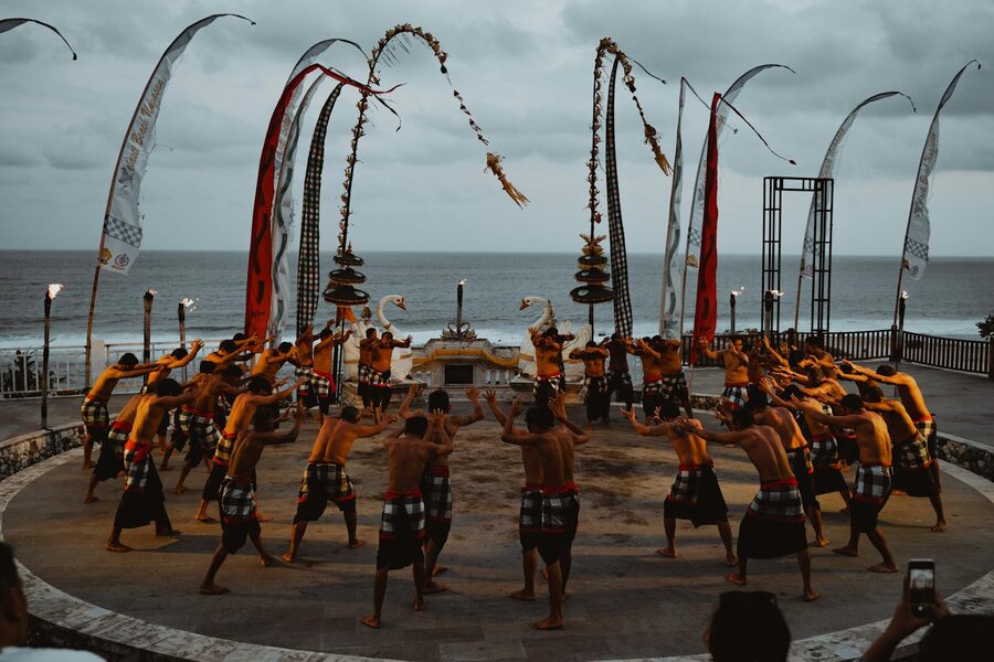 Traditional Kecak dance performed by Balinese men in white sarongs