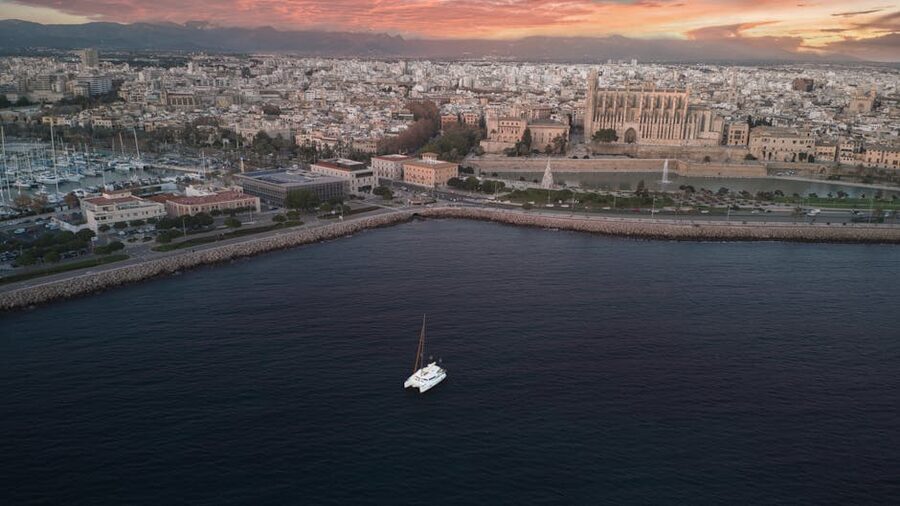 Aerial view of Palma Cathedral and yacht at sunset